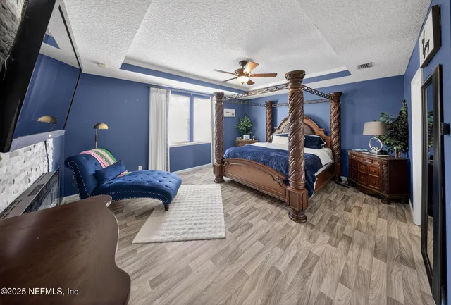 a bedroom with furniture and a large window