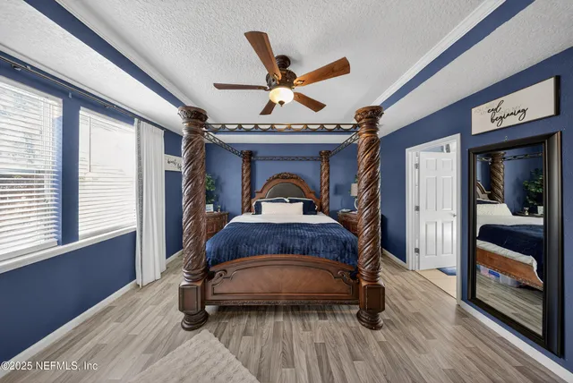 a bedroom with a bed and a large window