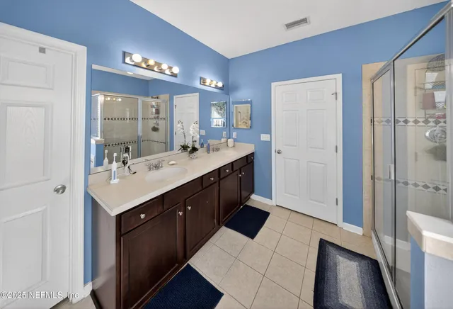 a bathroom with a sink vanity and a mirror