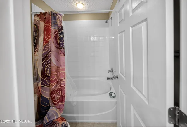 a bathroom with a bathtub and shower