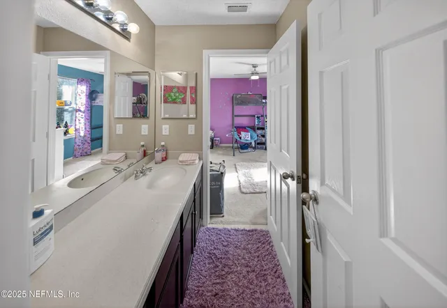 a bathroom with a sink vanity and a mirror