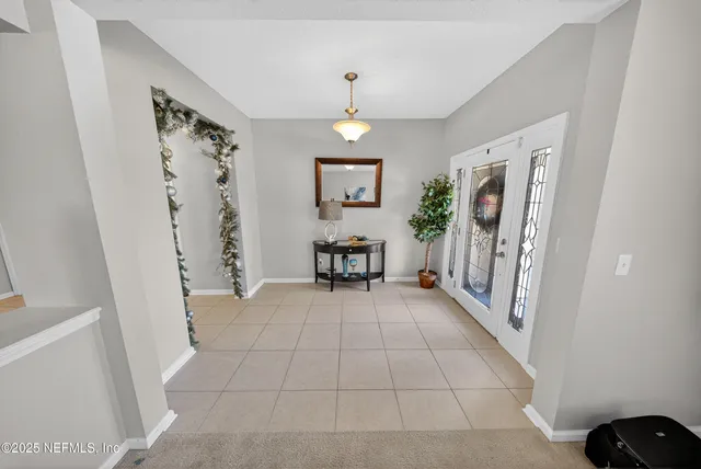 a view of a hallway with furniture and entryway
