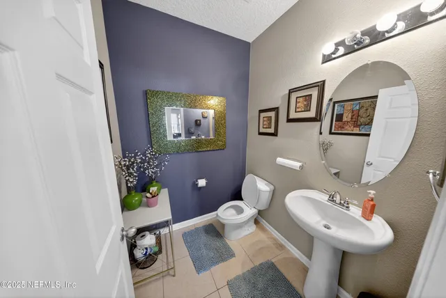 a bathroom with a sink mirror and toilet