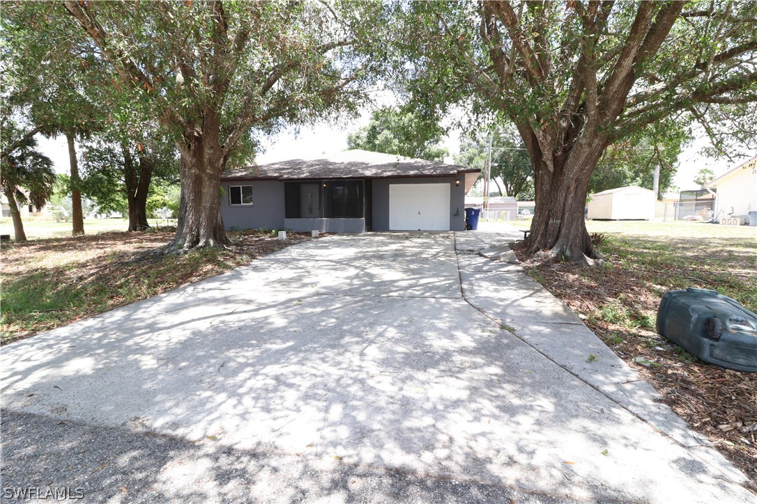 2102 Hibiscus Road Fort Myers, FL 33905 - Photo 1 of 23 a big tree in middle of the garden