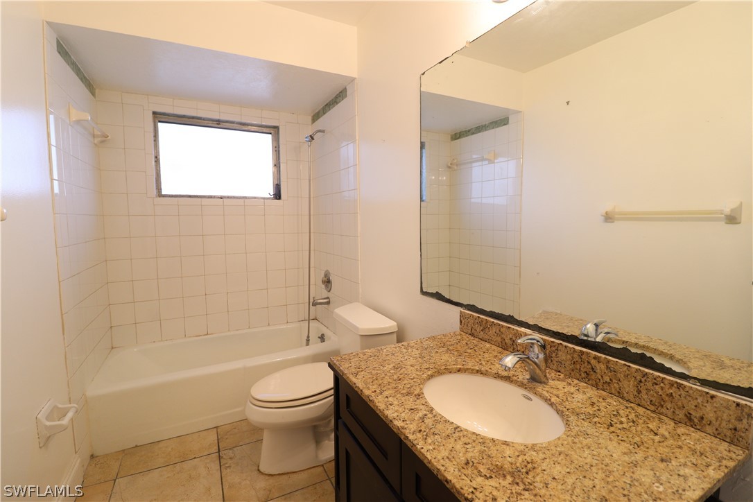 2102 Hibiscus Road Fort Myers, FL 33905 - Photo 15 of 23 a bathroom with a granite countertop sink and a mirror