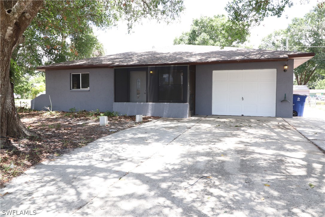2102 Hibiscus Road Fort Myers, FL 33905 - Photo 3 of 23 a front view of a house with a yard