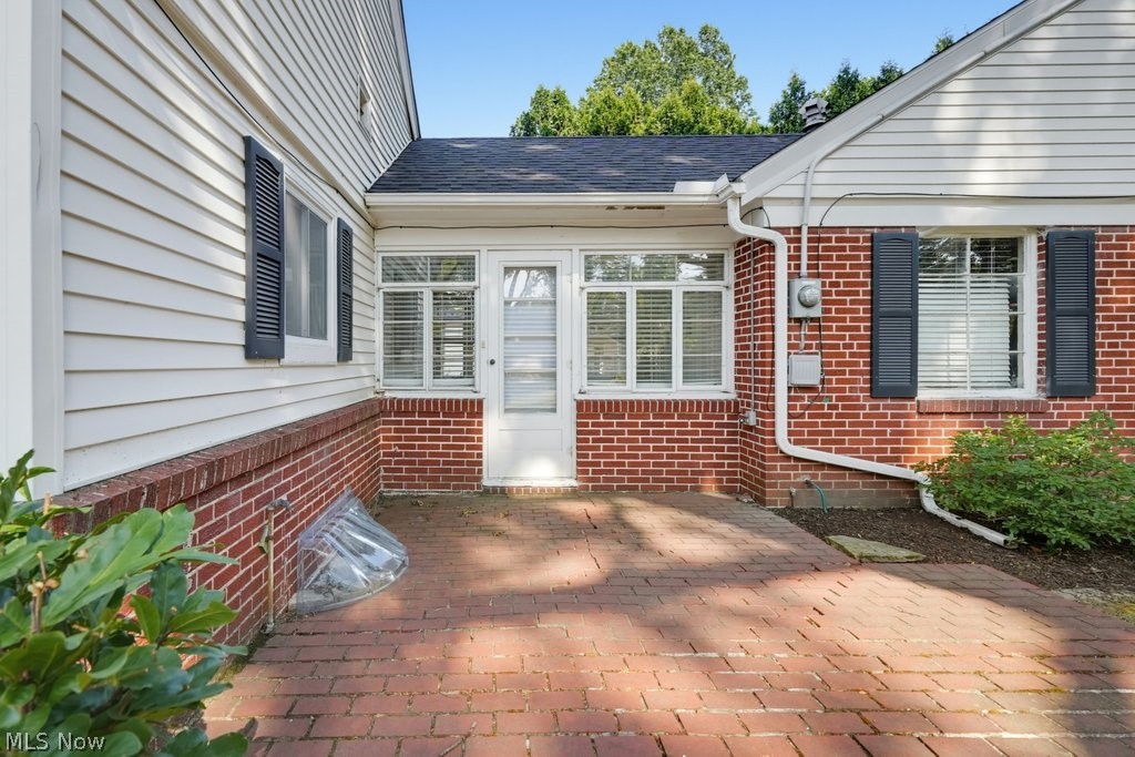 2468 Ridgewood Road Akron, OH 44313 - Photo 8 of 50 Brick paver patio with a brick and white siding exterior