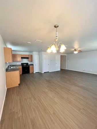 a view of a room with wooden floor