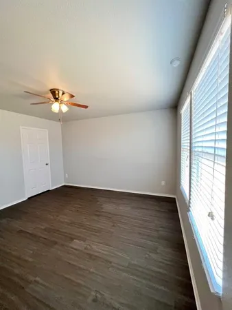 a view of a room with wooden floor and window