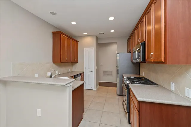 a kitchen with a sink a stove and cabinets