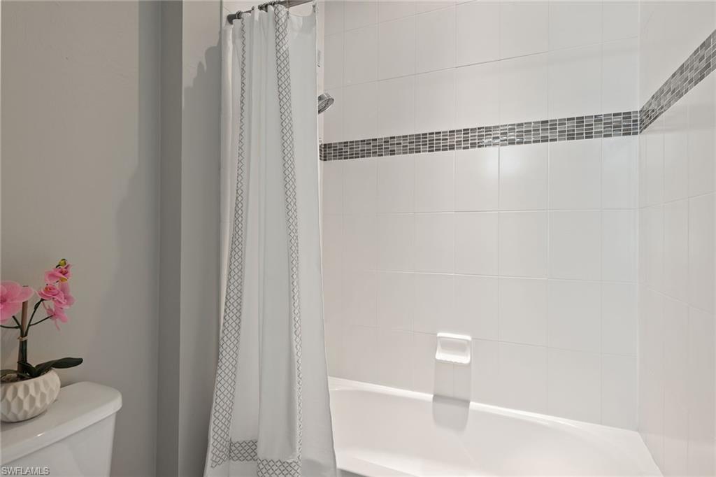 4359 Raffia Palm Circle Naples, FL 34119 - Photo 14 of 35 a bathroom with a shower and a toilet