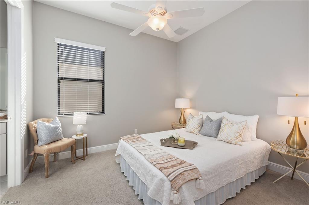 4359 Raffia Palm Circle Naples, FL 34119 - Photo 15 of 35 a bedroom with a bed and a couch