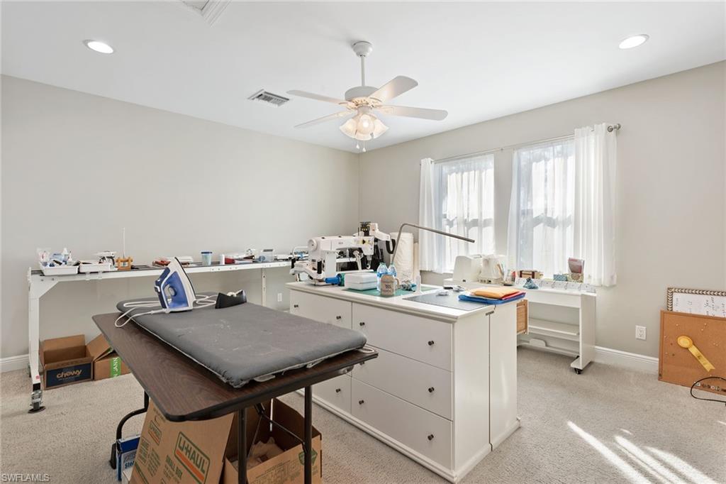 4359 Raffia Palm Circle Naples, FL 34119 - Photo 16 of 35 a view of a kitchen with a table and chairs