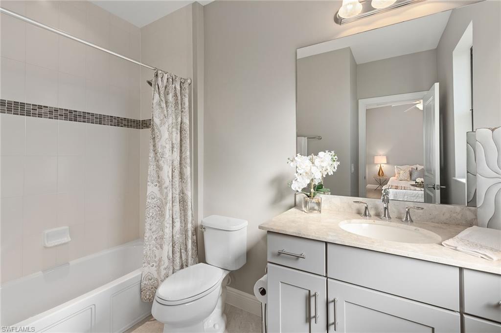 4359 Raffia Palm Circle Naples, FL 34119 - Photo 17 of 35 a bathroom with a sink toilet vanity tub and shower