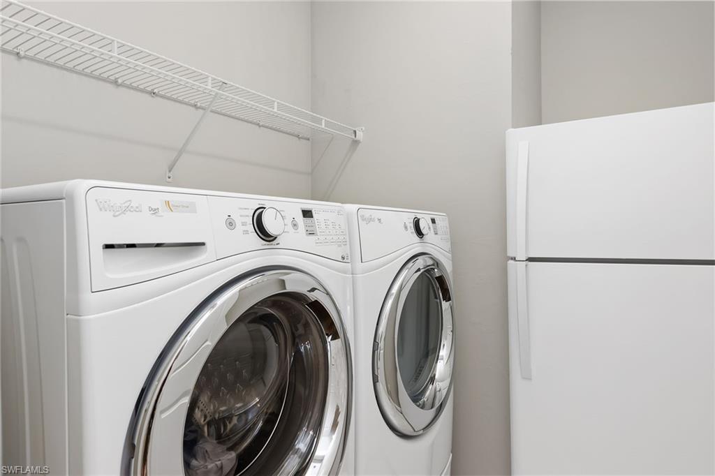 4359 Raffia Palm Circle Naples, FL 34119 - Photo 19 of 35 a utility room with dryer and washer