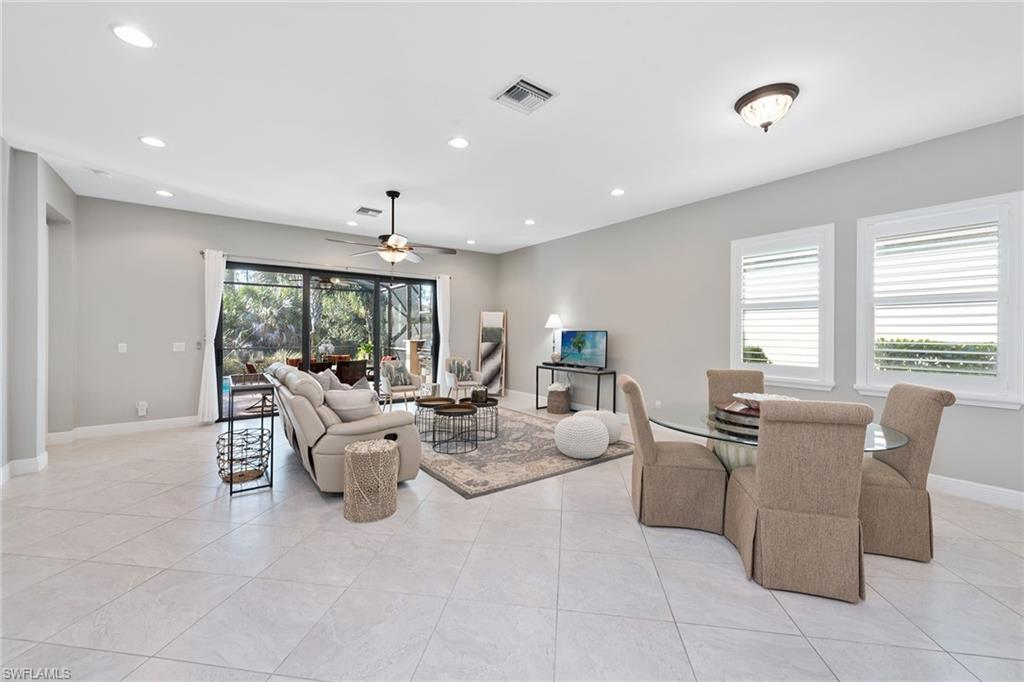 4359 Raffia Palm Circle Naples, FL 34119 - Photo 2 of 35 a living room with furniture large window and chairs