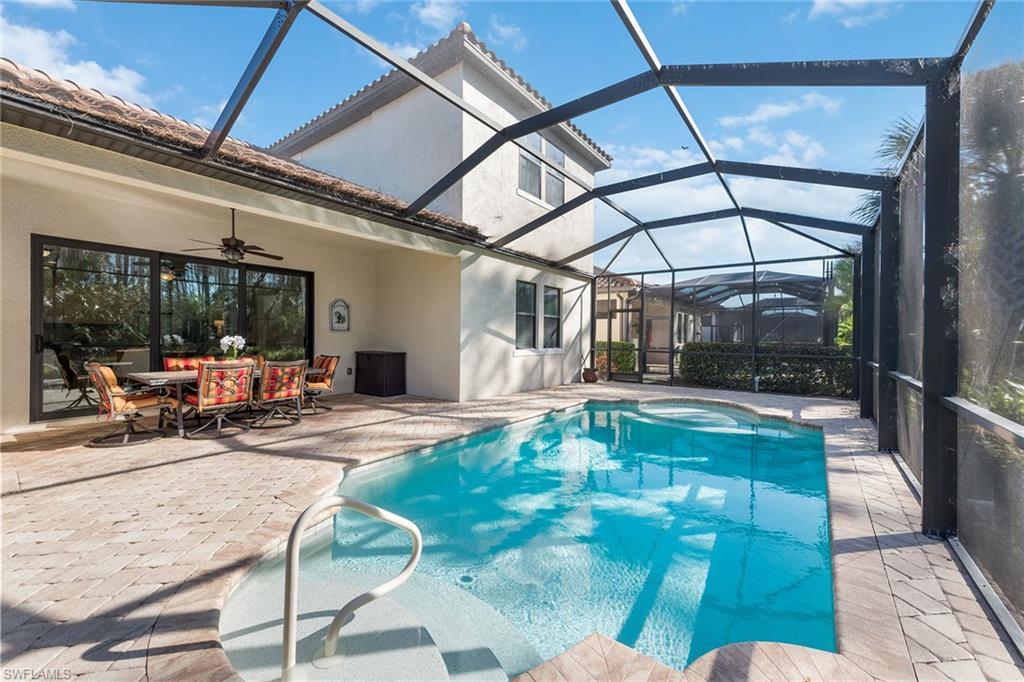 4359 Raffia Palm Circle Naples, FL 34119 - Photo 22 of 35 a view of a swimming pool with a patio