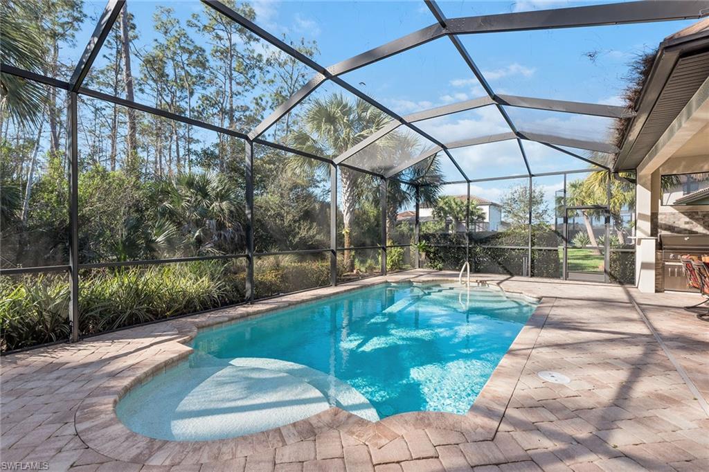 4359 Raffia Palm Circle Naples, FL 34119 - Photo 24 of 35 a view of a swimming pool with a patio