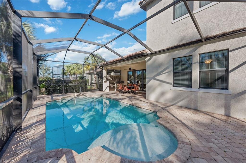 4359 Raffia Palm Circle Naples, FL 34119 - Photo 25 of 35 a view of a swimming pool with a patio