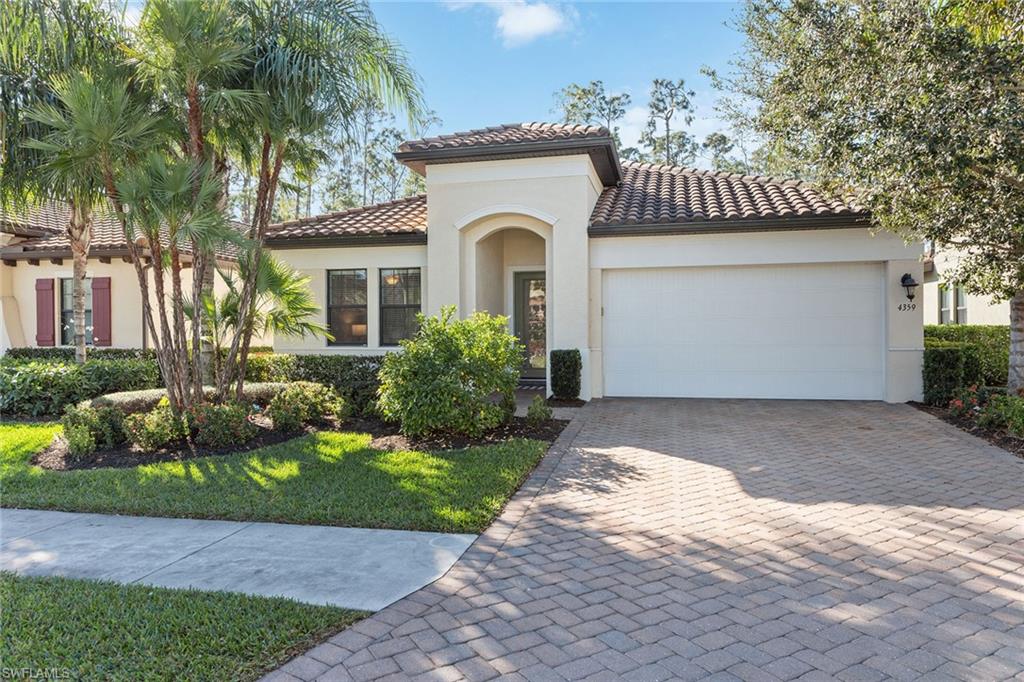 4359 Raffia Palm Circle Naples, FL 34119 - Photo 27 of 35 a front view of a house with a garden