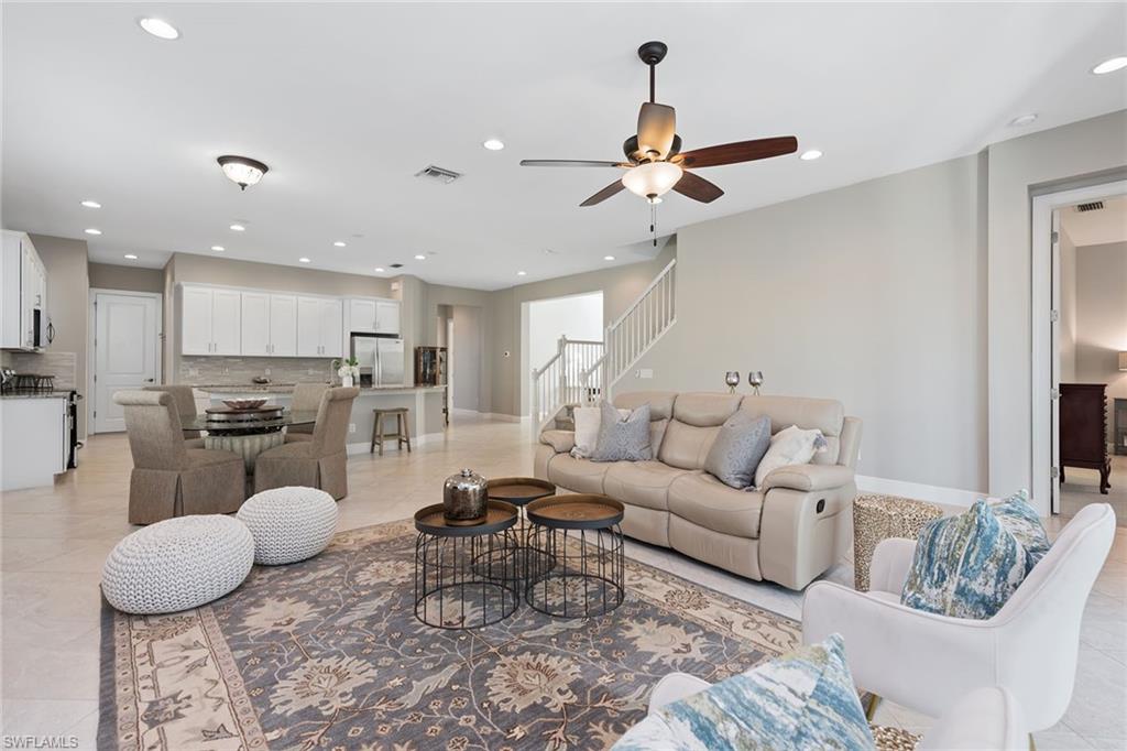 4359 Raffia Palm Circle Naples, FL 34119 - Photo 3 of 35 a living room with furniture and kitchen view
