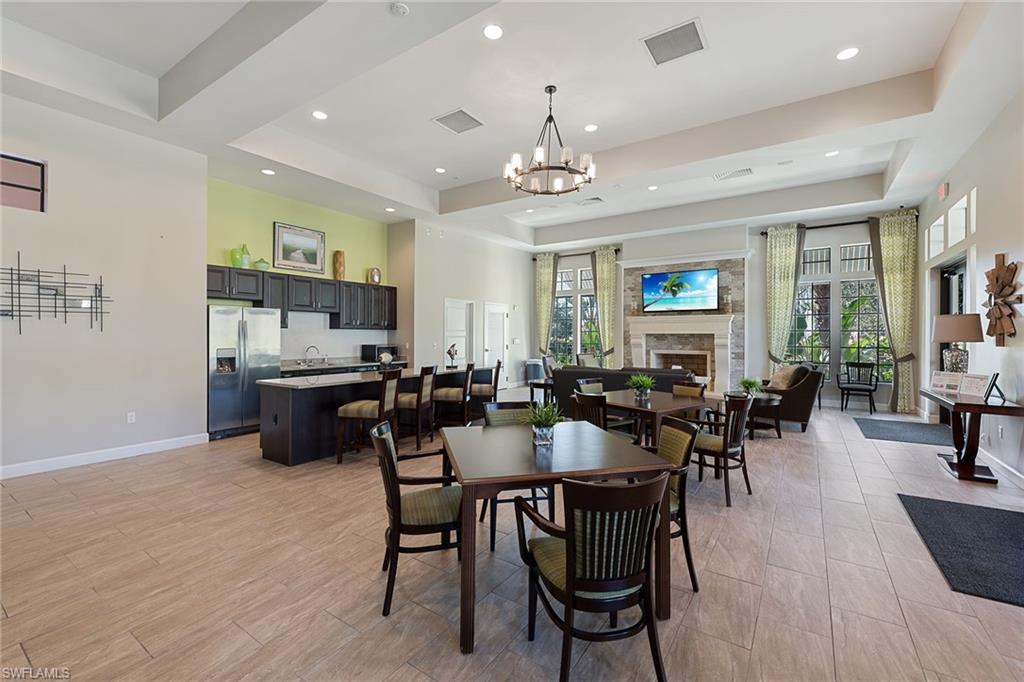 4359 Raffia Palm Circle Naples, FL 34119 - Photo 31 of 35 a view of a dining room with furniture and wooden floor