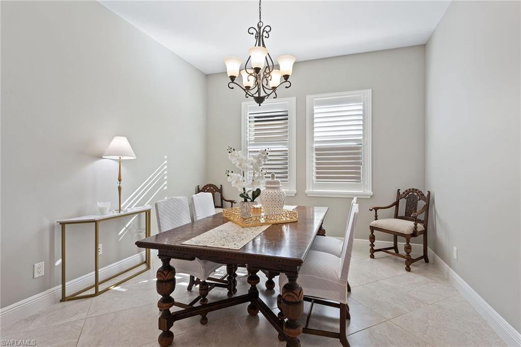 4359 Raffia Palm Circle Naples, FL 34119 - Photo 7 of 35 a view of a dining room with furniture and window