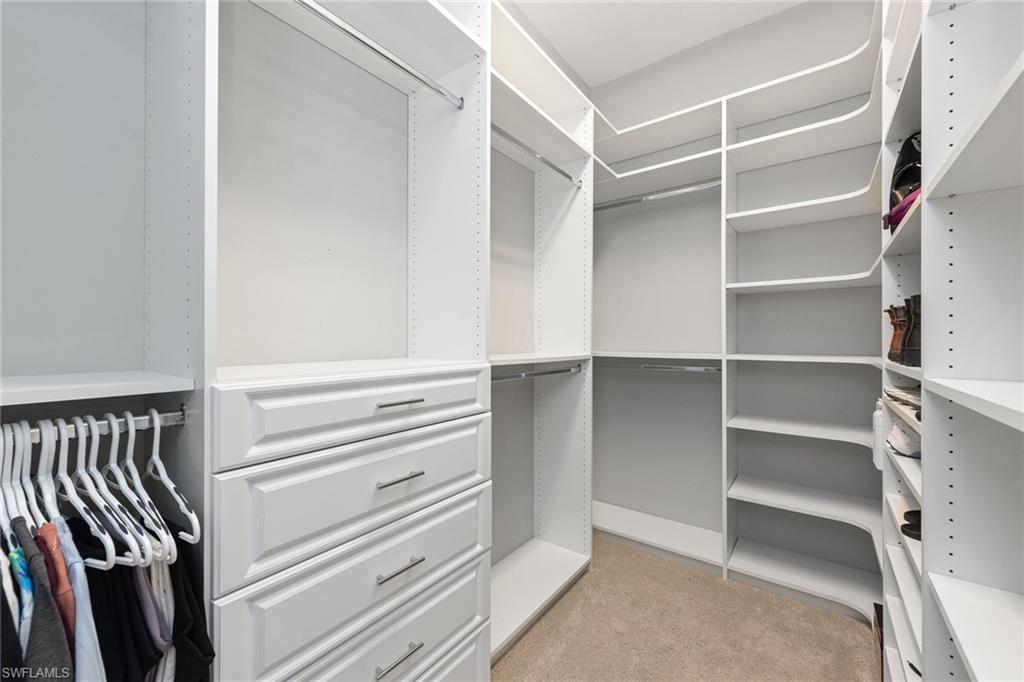 4359 Raffia Palm Circle Naples, FL 34119 - Photo 9 of 35 a view of walk in closet with empty racks
