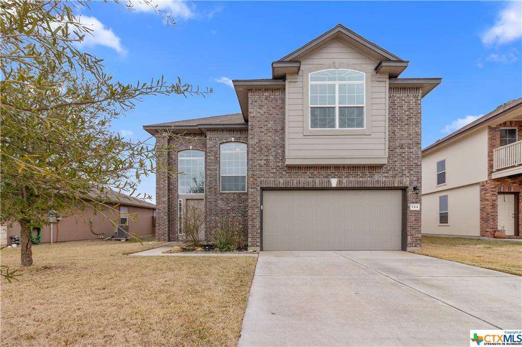 344 Foster Lane Jarrell, TX 76537 - Photo 1 of 1 a front view of a house with a yard and garage
