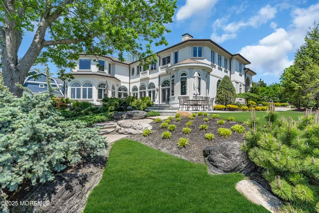 a living room with furniture a fireplace and a large window