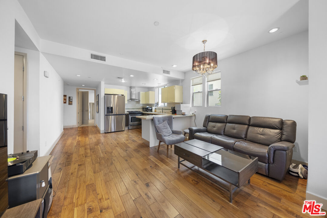 848 Irolo Street, Unit 105 Los Angeles, CA 90005 - Photo 12 of 18 a living room with furniture and a flat screen tv