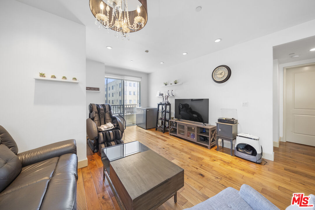 848 Irolo Street, Unit 105 Los Angeles, CA 90005 - Photo 14 of 18 a living room with furniture and a flat screen tv