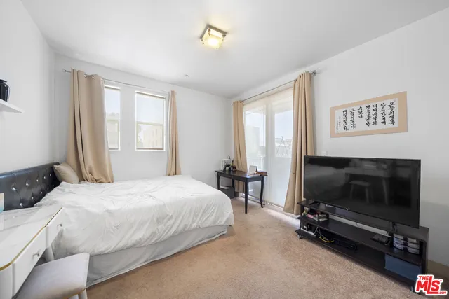 a bedroom with furniture and a window