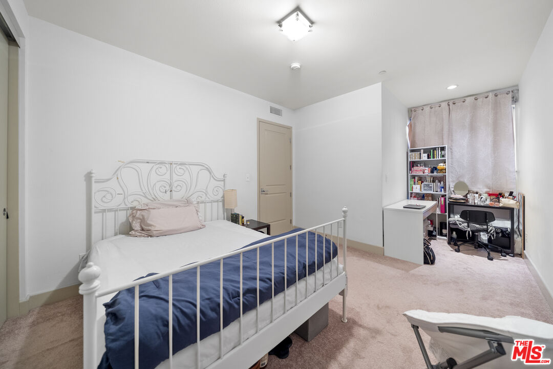 848 Irolo Street, Unit 105 Los Angeles, CA 90005 - Photo 16 of 18 a bedroom with furniture and a window