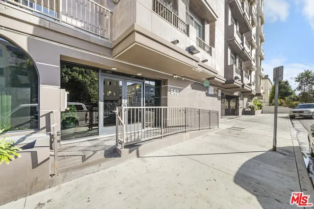 a view of a building with a bench in a patio