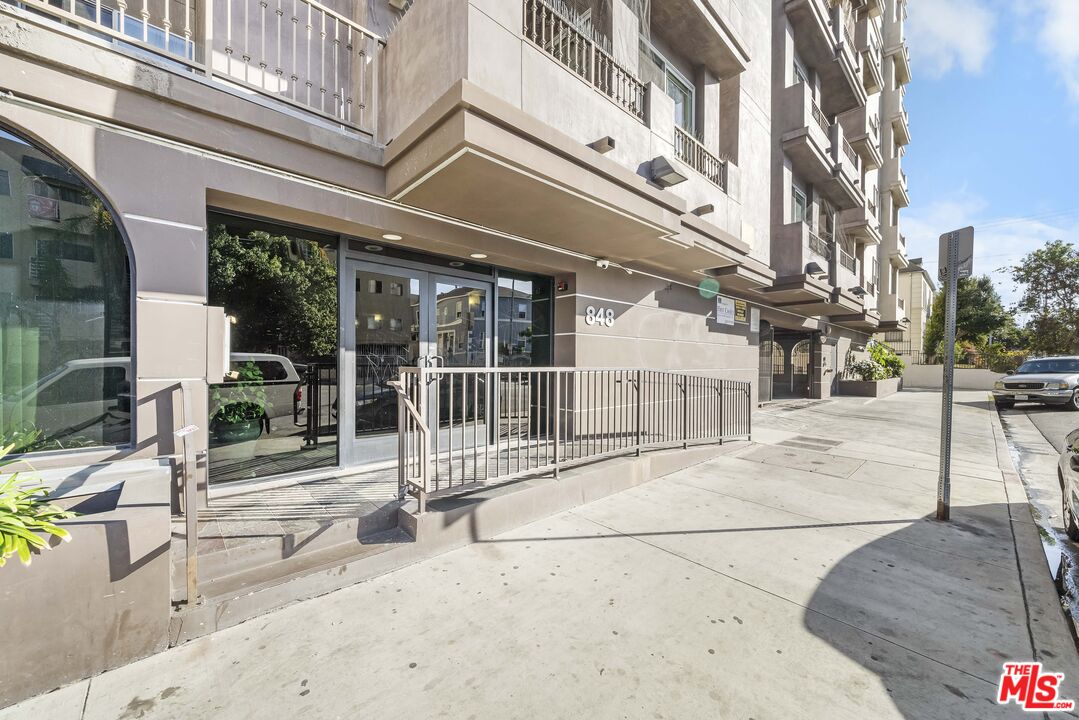 848 Irolo Street, Unit 105 Los Angeles, CA 90005 - Photo 4 of 18 a view of a building with a bench in a patio