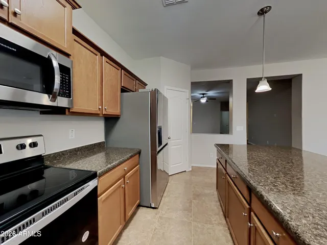 a kitchen with stainless steel appliances granite countertop a sink and a stove