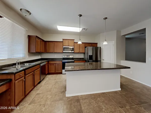 a large kitchen with stainless steel appliances and a sink