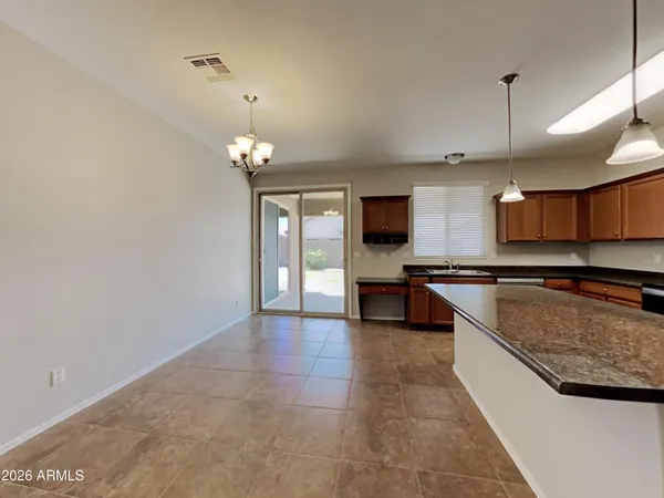 a large kitchen with a large counter top and kitchen space