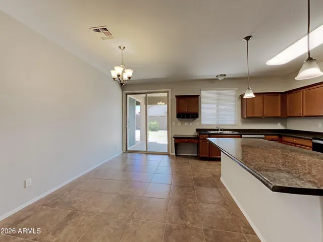 a large kitchen with a large counter top and kitchen space