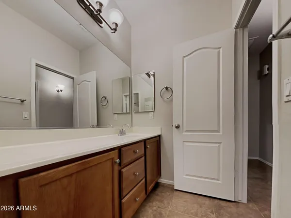 a spacious bathroom with a double vanity sink and mirror