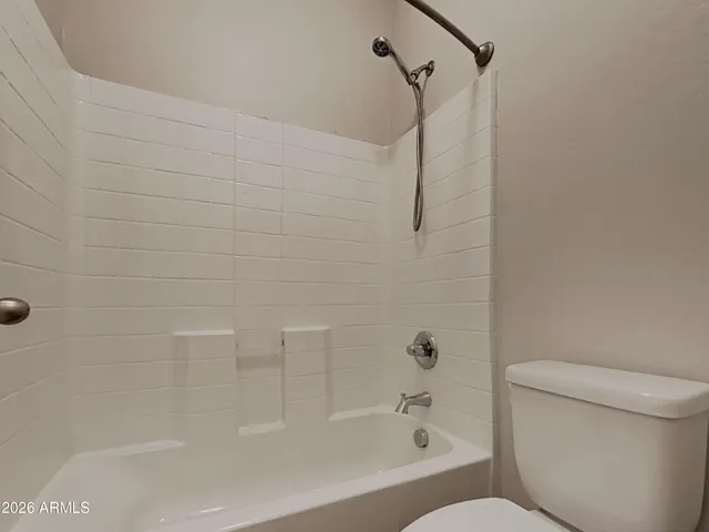 a bathroom with a bathtub and a toilet