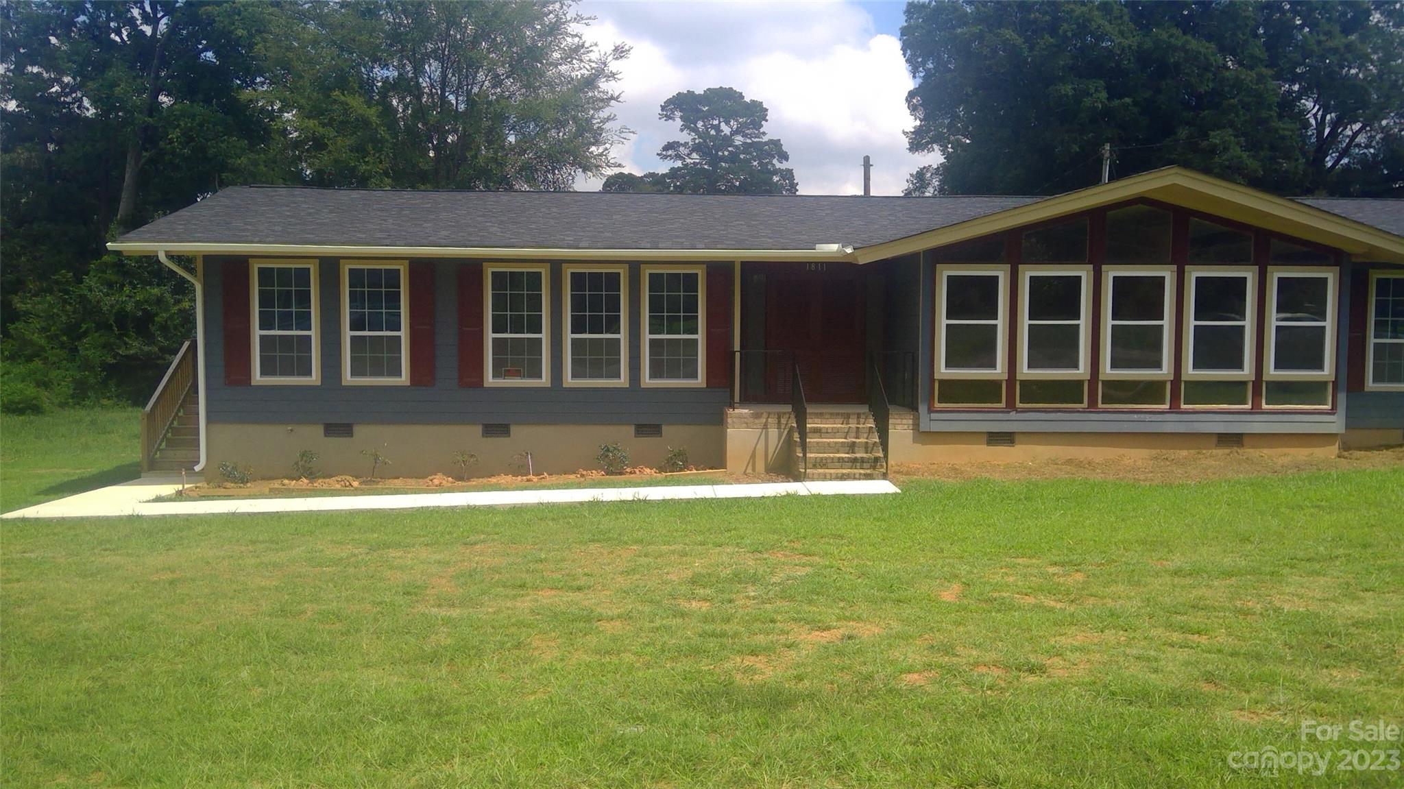 1811 Little Rock Road Charlotte, NC 28214 - Photo 1 of 20 a front view of a house with a garden