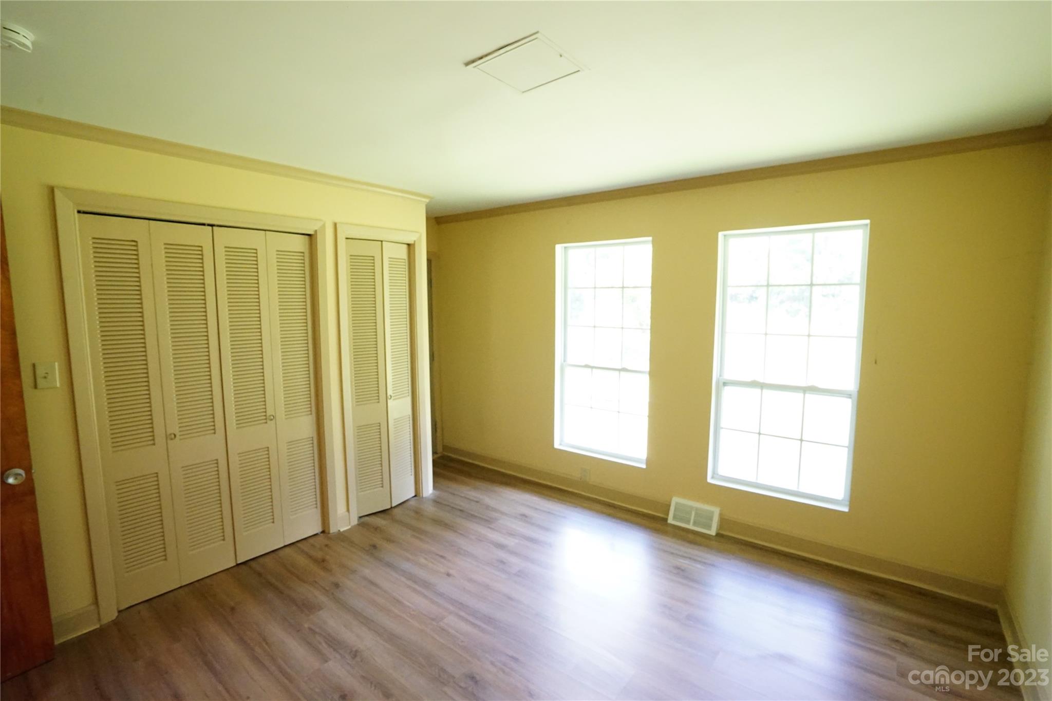 1811 Little Rock Road Charlotte, NC 28214 - Photo 14 of 20 a view of an empty room with wooden floor and a window