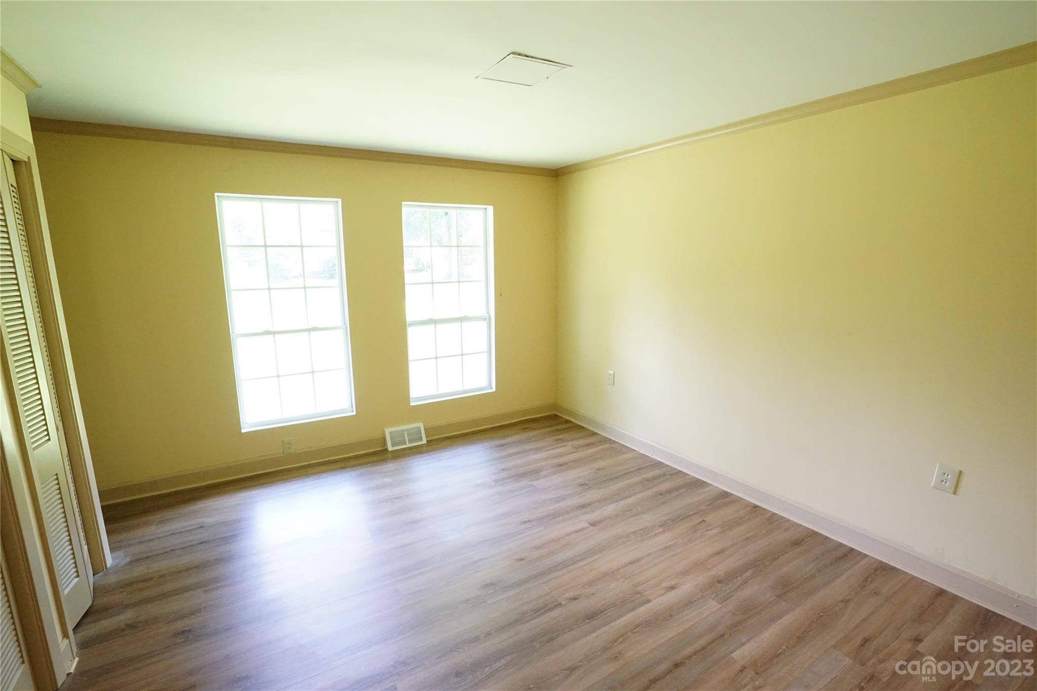 1811 Little Rock Road Charlotte, NC 28214 - Photo 15 of 20 an empty room with wooden floor and a window