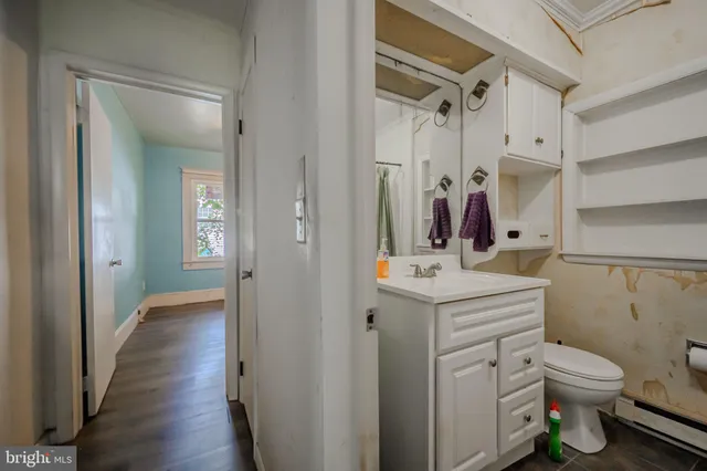 a bathroom with a toilet sink and mirror