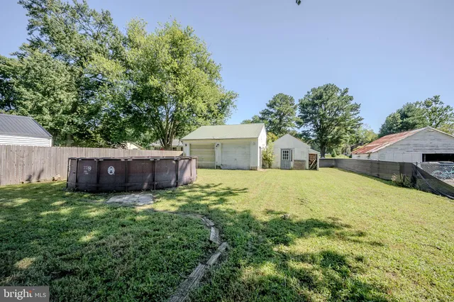 a view of a house with a yard and a garage
