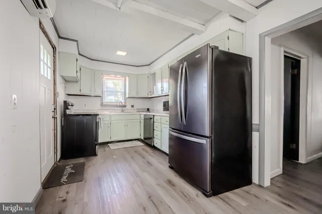 a kitchen with stainless steel appliances a refrigerator and a sink