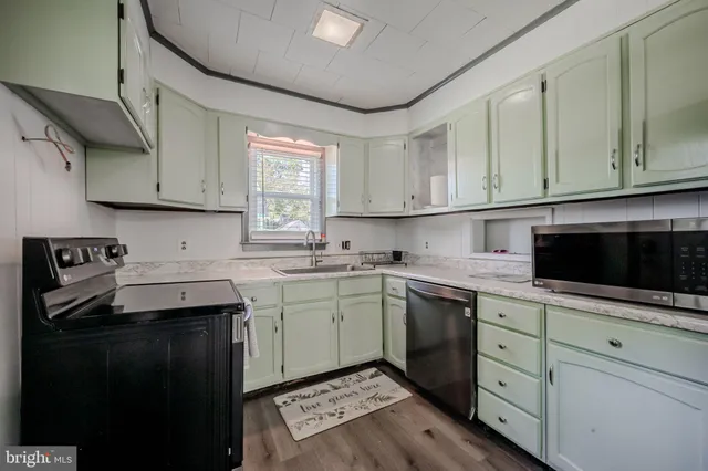 a kitchen with a sink stove and cabinets