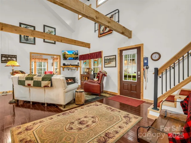 a living room with fireplace furniture and a wooden floor